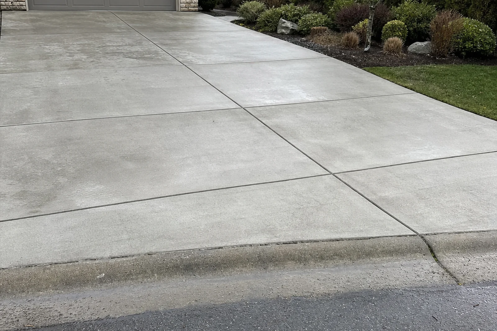 Concrete driveway correct drainage pitch Redmond Washington King County Pacific Northwest rain sheeting residential Kevin